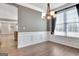 Dining room featuring hardwood floors, modern lighting fixture and large bright window at 704 Pine Grove Cir, Peachtree City, GA 30269