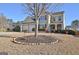 Two-story house with a large yard, two-car garage, and landscaping at 704 Pine Grove Cir, Peachtree City, GA 30269
