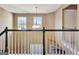 Foyer featuring hardwood floors, a white staircase, and pendant lighting at 704 Pine Grove Cir, Peachtree City, GA 30269