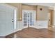 Open foyer with white trim, dark hardwood, and bright lighting with french doors at 704 Pine Grove Cir, Peachtree City, GA 30269