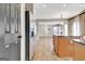Kitchen area with stainless refrigerator, island, and view into another room at 704 Pine Grove Cir, Peachtree City, GA 30269