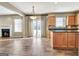 Bright open-concept kitchen with stainless appliances and adjacent sitting area with fireplace at 704 Pine Grove Cir, Peachtree City, GA 30269