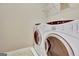 Laundry room with a white washer and dryer and storage shelf at 704 Pine Grove Cir, Peachtree City, GA 30269