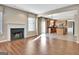 Open-concept living space with fireplace that leads to the kitchen at 704 Pine Grove Cir, Peachtree City, GA 30269