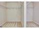 A walk-in closet with a carpeted floor and metal shelving at 704 Pine Grove Cir, Peachtree City, GA 30269