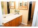 Double vanity bathroom with wood cabinets and large mirror at 756 Stonehaven Chase, Mcdonough, GA 30253
