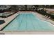 Community pool with chairs, tables, and ladders for residents to enjoy a refreshing swim at 756 Stonehaven Chase, Mcdonough, GA 30253
