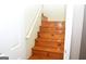 Wooden staircase with a simple handrail at 756 Stonehaven Chase, Mcdonough, GA 30253