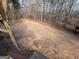 Large backyard with a tree line and sparse ground cover at 135 Tuscany Trce, Dallas, GA 30157