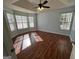Bright bedroom with hardwood floors and a large bay window, offering ample natural light at 135 Tuscany Trce, Dallas, GA 30157
