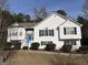 Two-story house with white siding, blue door, and landscaping at 135 Tuscany Trce, Dallas, GA 30157