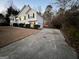 House exterior view at dusk with a long driveway and fenced backyard at 135 Tuscany Trce, Dallas, GA 30157