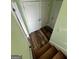 Hallway with light green walls and wood flooring at 135 Tuscany Trce, Dallas, GA 30157
