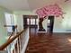 Spacious living room featuring hardwood floors, a large window, and a unique wall mural at 135 Tuscany Trce, Dallas, GA 30157