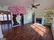Living room with a large cherry blossom mural, fireplace, and hardwood floors at 135 Tuscany Trce, Dallas, GA 30157