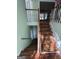 Wooden staircase with light green walls and wood flooring at 135 Tuscany Trce, Dallas, GA 30157