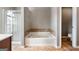 Main bathroom with a large tub, shower, and double vanity at 985 Buckhorn Bnd, Locust Grove, GA 30248