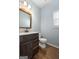 Charming bathroom with dark brown vanity, white toilet and a white sink at 985 Buckhorn Bnd, Locust Grove, GA 30248