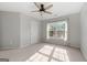 Well-lit bedroom featuring a ceiling fan and window at 985 Buckhorn Bnd, Locust Grove, GA 30248