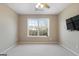 Bedroom with large window, ceiling fan and TV mount at 985 Buckhorn Bnd, Locust Grove, GA 30248