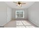 Bright bedroom with ceiling fan and large window at 985 Buckhorn Bnd, Locust Grove, GA 30248