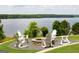 Relaxing fire pit with lake view and rocking chairs at 985 Buckhorn Bnd, Locust Grove, GA 30248