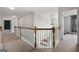 Upstairs hallway with white railing and carpet flooring, leading to bedrooms at 985 Buckhorn Bnd, Locust Grove, GA 30248