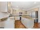 Modern kitchen with stainless steel appliances and island at 985 Buckhorn Bnd, Locust Grove, GA 30248