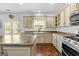 Modern kitchen with island and view to backyard at 985 Buckhorn Bnd, Locust Grove, GA 30248