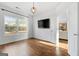 Bright living room features hardwood floors, large windows, and a view of the backyard at 985 Buckhorn Bnd, Locust Grove, GA 30248