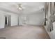 Spacious main bedroom with neutral carpeting, two windows, and a ceiling fan at 985 Buckhorn Bnd, Locust Grove, GA 30248