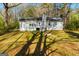Backyard view of house showcasing the home's back exterior, patio, and lush, wooded lot at 633 Westbridge Rd, Fayetteville, GA 30214