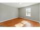 Bedroom with neutral paint, large window and laminate floors at 633 Westbridge Rd, Fayetteville, GA 30214