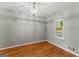 Bright bedroom with hardwood floors, overhead light, and a window at 633 Westbridge Rd, Fayetteville, GA 30214