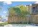 Condo building exterior with wooden privacy fence and small balcony at 6036 Regent Mnr, Lithonia, GA 30058