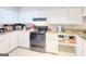 Small kitchen with white cabinets and a black stove at 6036 Regent Mnr, Lithonia, GA 30058