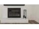 Close-up of a painted brick fireplace with a dark mantle and floor at 6667 Ridge Moore Dr, Peachtree Corners, GA 30360