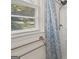 Close-up of a shower with a blue-patterned curtain and a towel bar at 6667 Ridge Moore Dr, Peachtree Corners, GA 30360