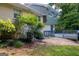 Backyard featuring a deck, a mix of greenery, and views of the home's exterior at 6667 Ridge Moore Dr, Peachtree Corners, GA 30360