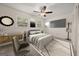 Staged bedroom with a large bed, dresser, and TV at 6667 Ridge Moore Dr, Peachtree Corners, GA 30360