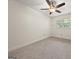 Neutral bedroom with a ceiling fan and large window at 6667 Ridge Moore Dr, Peachtree Corners, GA 30360