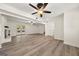 Spacious living room with fireplace, vinyl floors, and a ceiling fan at 6667 Ridge Moore Dr, Peachtree Corners, GA 30360
