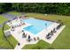 Community pool featuring lounge chairs, tables, and umbrellas at 6667 Ridge Moore Dr, Peachtree Corners, GA 30360