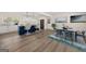 Modern kitchen and dining area with blue island, light wood floors, and decor at 6667 Ridge Moore Dr, Peachtree Corners, GA 30360
