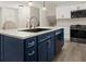 Modern kitchen with white cabinets, stainless steel appliances, and a central island with sink at 6667 Ridge Moore Dr, Peachtree Corners, GA 30360