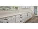 Bright laundry room with white shaker cabinets, quartz countertops, and black hardware at 6667 Ridge Moore Dr, Peachtree Corners, GA 30360