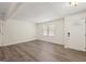 Open-concept living room with new flooring, large windows, and a stylish front door at 6667 Ridge Moore Dr, Peachtree Corners, GA 30360