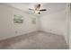Bright bedroom with neutral carpet, two windows, ceiling fan, and closet at 6667 Ridge Moore Dr, Peachtree Corners, GA 30360