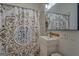 Small bathroom with patterned shower curtain and pedestal sink at 2173 Anderson Se Ave, Covington, GA 30014