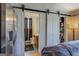 Bedroom with sliding barn doors to bathroom and closet at 2173 Anderson Se Ave, Covington, GA 30014